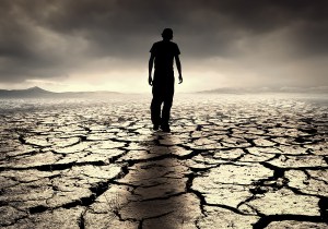 A young man walks into the desolate desert